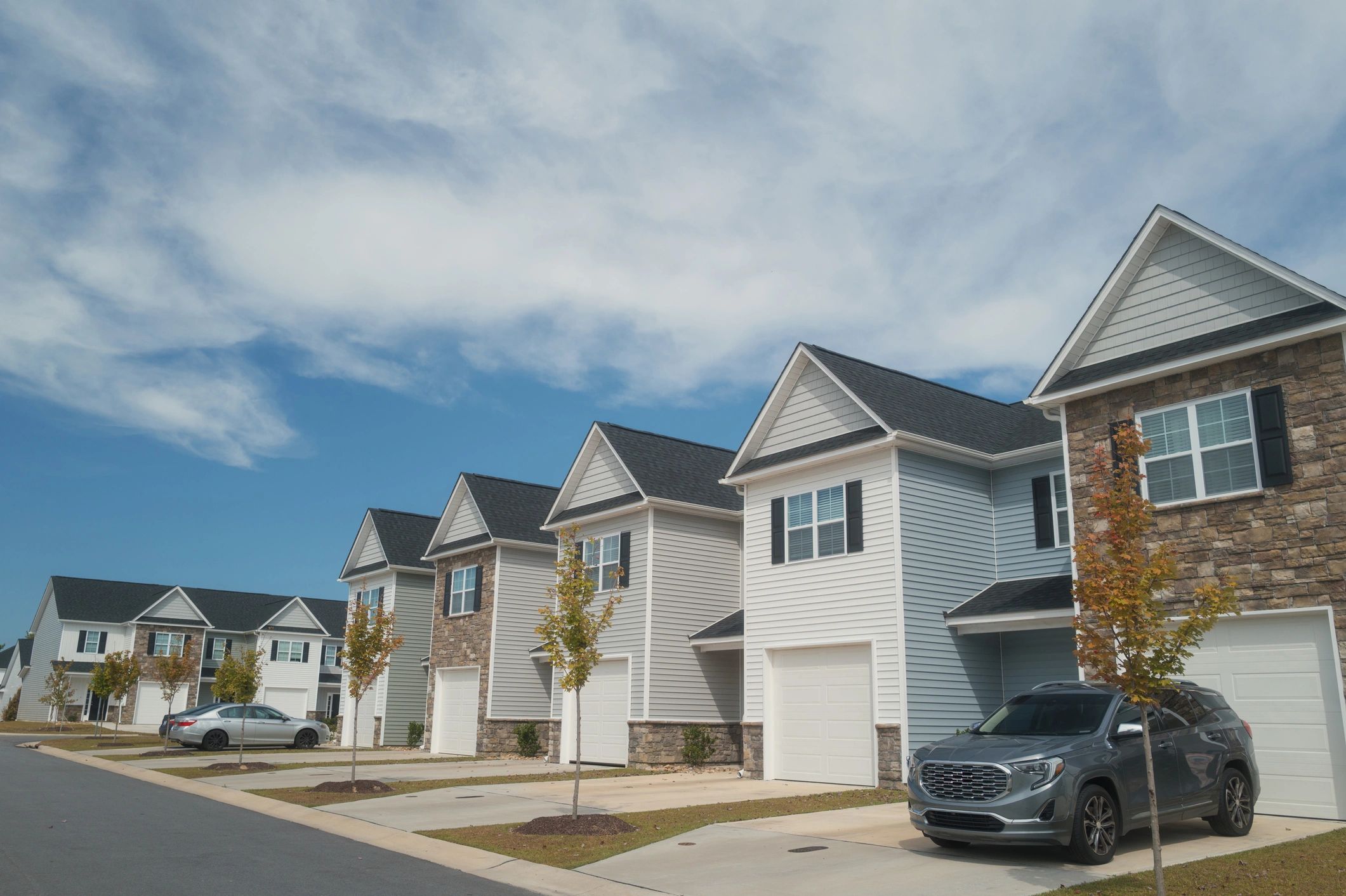 Row of townhouses under a clear blue sky